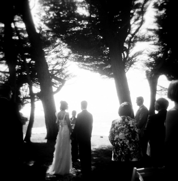 Ceremony shot of bride and groom and nature backdrop in black and white - wedding photo by top Austin based wedding photographers Q Weddings